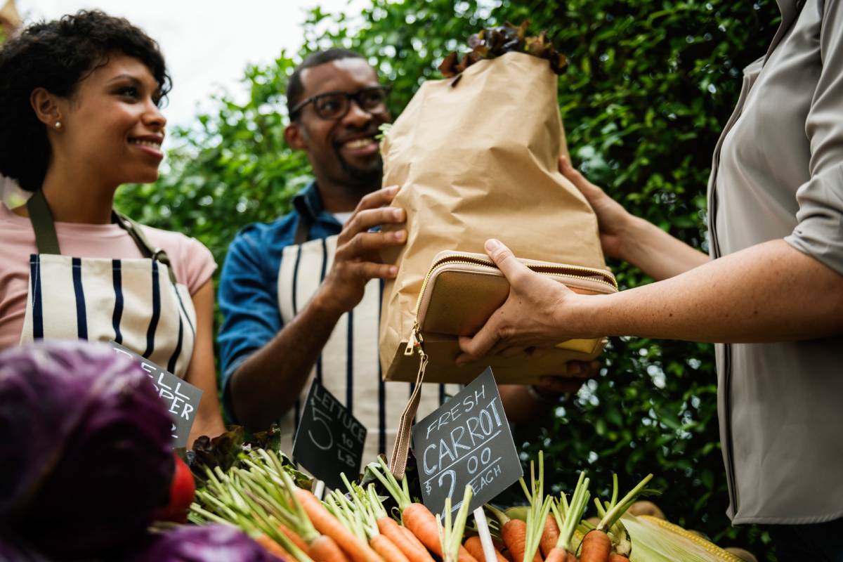 People Buying Vegetable From Shop at Market